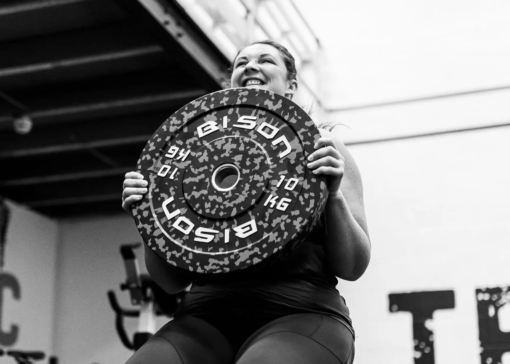 Client holding weights during a training session at TeamNTS Exeter