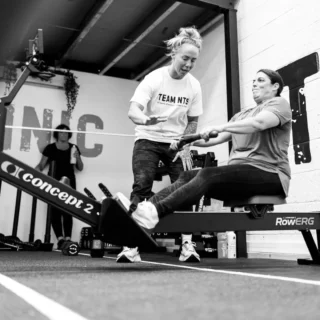 Client rowing during a high-intensity Hyrox class at TEAM NTS in Exeter