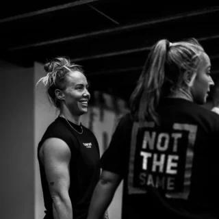 Two clients discussing their workout at TEAM NTS gym in Exeter.